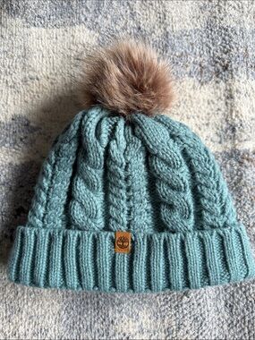 Timberland Women’sTeal Cable Knit Sherpa Lined Beanie with Faux Fur Pom